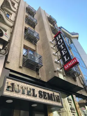 a building with a sign for a sushi scramble at Hotel Semih in Istanbul