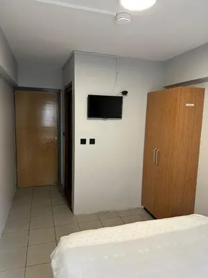 a bedroom with a bed and a tv on the wall at Hotel Semih in Istanbul