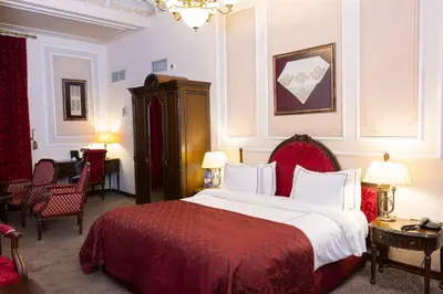 a bedroom with a large bed with a red blanket at Anemon Koleksiyon Galata Otel in Istanbul