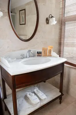 a bathroom with a sink and a mirror at Anemon Koleksiyon Galata Otel in Istanbul