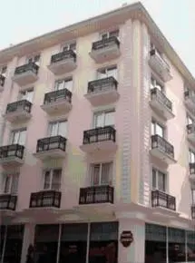a tall white building with balconies on it at Sembol Hotel in Istanbul