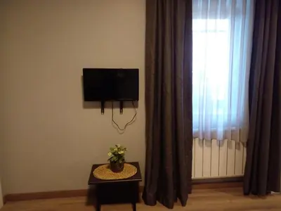 a living room with a flat screen tv and a window at Kaftan Hotel in Istanbul