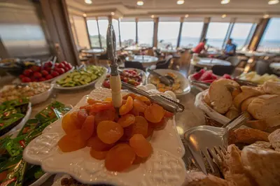 a buffet of food with a candle on a table at Kaftan Hotel in Istanbul