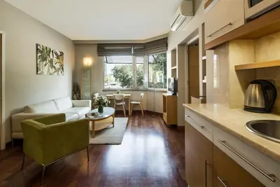 a kitchen and living room with a couch and a table at Taxim Suites Residences Istanbul in Istanbul
