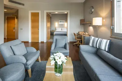 a living room with a couch and two chairs at Taxim Suites Residences Istanbul in Istanbul
