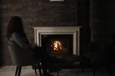 a woman sitting in a chair in front of a fireplace at The Golden Pera's Hotel & Spa in Istanbul