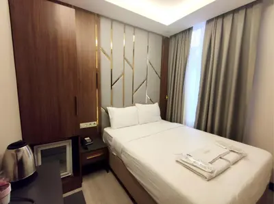 a hotel room with a bed and a television at The Golden Pera's Hotel & Spa in Istanbul