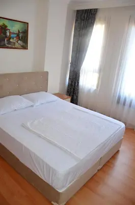 a white bed in a bedroom with a window at Baran Home Aparts in Istanbul