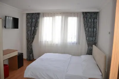 a bedroom with a white bed and a window at Baran Home Aparts in Istanbul