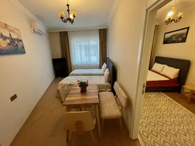 a room with a bed and a table and a bedroom at Oldtown Sultanahmet Suites in Istanbul
