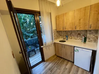 a kitchen with wooden cabinets and a sink and a window at Oldtown Sultanahmet Suites in Istanbul