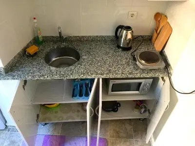 a kitchen counter with a sink and a microwave at Oldtown Sultanahmet Suites in Istanbul