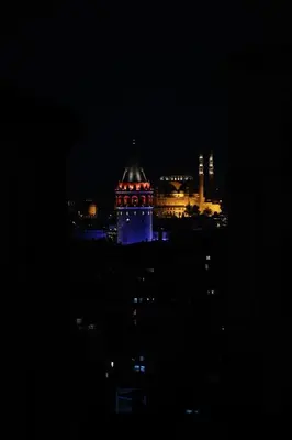 a night view of a building with red lights at Hotel Naumpasa Konagi in Istanbul