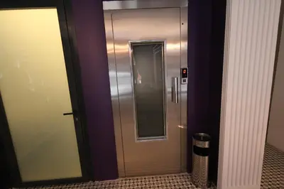 a elevator in a building with a mirror at Hotel Naumpasa Konagi in Istanbul