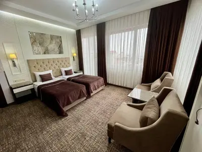 a hotel room with two beds and a couch at City Center Hotel Taksim İstanbul in Istanbul