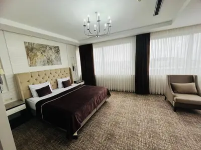 a bedroom with a large bed and a chair at City Center Hotel Taksim İstanbul in Istanbul