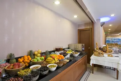 a buffet line with bowls of fruits and vegetables at Tugcu Hotel Select in Bursa