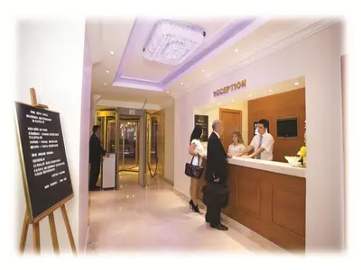 a man and woman standing at a counter in a bathroom at The City Hotel in Istanbul