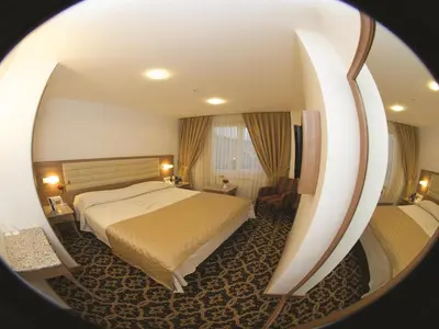 a hotel room with a bed and a mirror at The City Hotel in Istanbul