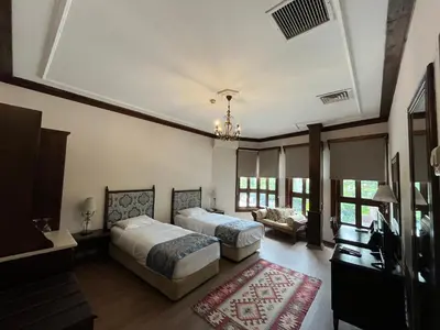 a bedroom with two beds and a couch at Otantik Hotel & Spa in Bursa