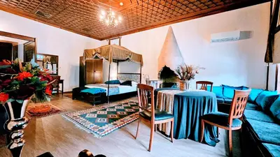 a living room with a bed and a table and chairs at Otantik Hotel & Spa in Bursa