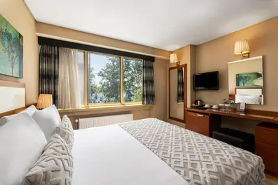 a hotel room with a bed and a window at Istanbul Golden City Hotel in Istanbul