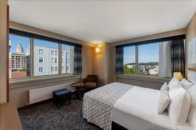 a hotel room with a bed and large windows at Istanbul Golden City Hotel in Istanbul