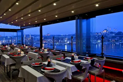 a restaurant with tables and chairs and large windows at Istanbul Golden City Hotel in Istanbul