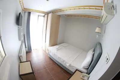 a small room with a bed and a window at Ares Hotel in Istanbul