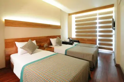 a hotel room with two beds and a window at Hotel Buyuk Keban in Istanbul