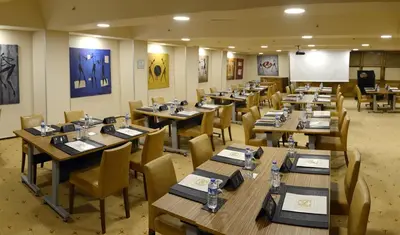 a dining room with wooden tables and chairs at Hotel Buyuk Keban in Istanbul