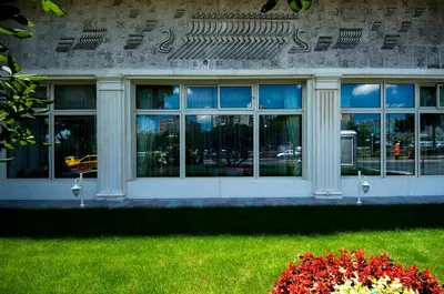 a building with a bunch of windows in the grass at Akgun Istanbul Hotel, WorldHotels Elite in Istanbul