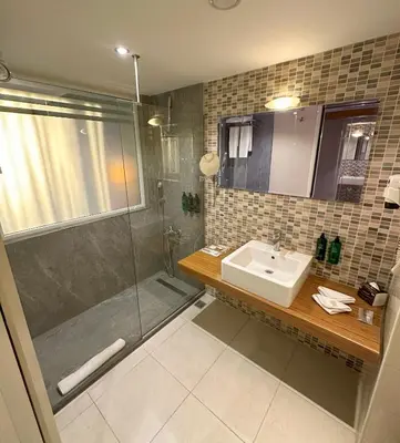 a bathroom with a sink and a shower at Akgun Istanbul Hotel, WorldHotels Elite in Istanbul