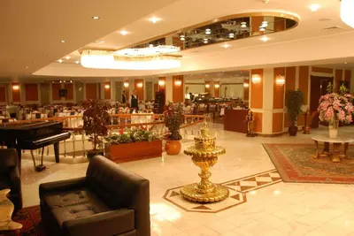 a lobby of a hotel with a piano and a table at Akgun Istanbul Hotel, WorldHotels Elite in Istanbul