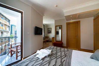 a hotel room with a bed and a balcony at Levent Hotel Istanbul in Istanbul