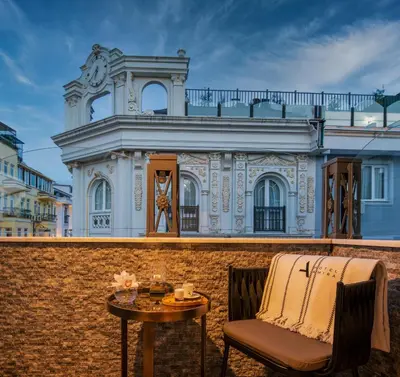 a chair and table in front of a building at Hotel Amira Istanbul in Istanbul