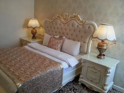 a bedroom with a bed and two lamps on tables at Best Town Hotel in Istanbul