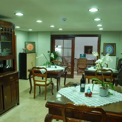 a living room with tables and chairs and a dining room at Villa Sphendone Suites Istanbul in Istanbul