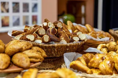 a table topped with baskets of bread and pastries at Raymond Hotel Old City in Istanbul
