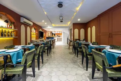 a dining room with tables and chairs with blue table cloth at Raymond Hotel Old City in Istanbul