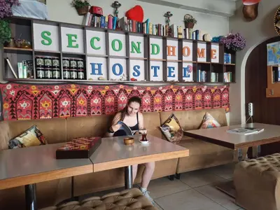 a woman sitting at a counter in a restaurant at Second Home Hostel in Istanbul