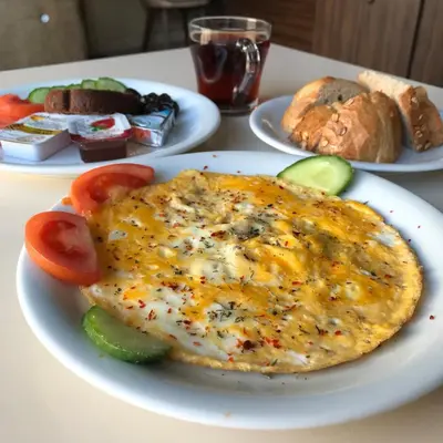 a plate of food with an omelet on a table at Second Home Hostel in Istanbul