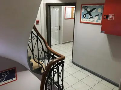 a hallway with a stairway leading to a door at Second Home Hostel in Istanbul