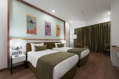 a hotel room with two beds in a room at ISG Sabiha Gökçen Airport Hotel in Istanbul