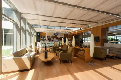 a lobby with couches and tables and chairs at ISG Sabiha Gökçen Airport Hotel in Istanbul