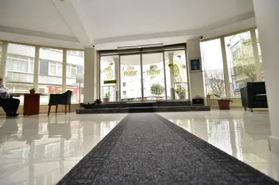 a lobby with a person sitting at a desk in a building at Hotel Topkapı in Istanbul