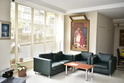 a living room with couches and a table and a painting at Hotel Topkapı in Istanbul
