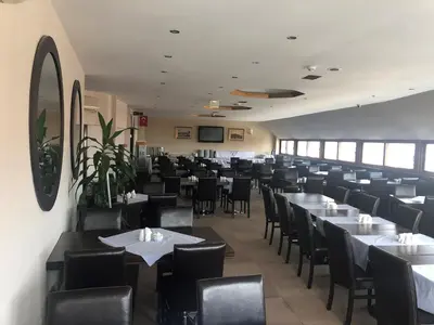 a dining room with tables and chairs in a restaurant at Hotel Topkapı in Istanbul