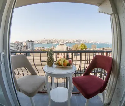 a table with a bowl of fruit on a balcony at Grand Esen Hotel in Istanbul