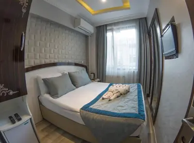 a bedroom with a bed with stuffed animals on it at Grand Esen Hotel in Istanbul